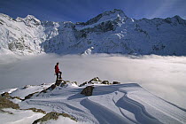 Mt Sefton, climber above cloud-filled Mueller Glacier, Mt Cook National Park, New Zealand