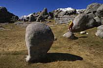 Castle Hill limestone boulders, walker explores boulders in winter, near Christchurch, New Zealand
