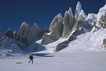 Skier pulling sledge near Cerro Torre, Los Glaciares National Park, Patagonia, Argentina