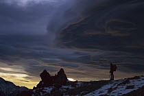 Hiker and storm clouds at dawn, Mount Fyffe, Kaikoura, New Zealand