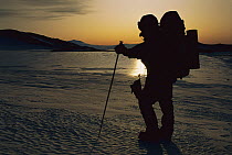 Mountaineer carrying load across polished sea ice, Ross Ice Shelf, Antarctica
