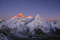 Moon over summit of Mount Everest, Lhotse, and Nuptse as seen from Mount Pumori, Sagarmatha National Park, Nepal