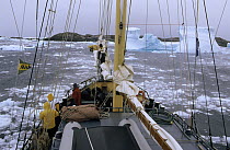Sailboat navigating through broken ice, Penola Strait, Argentine Islands, Antarctica