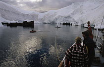 Tourists on cruise ship waving to others in zodiac, Gerlache Strait, Antarctica