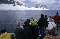 Tourists viewing landscape from deck of cruise ship, Gerlache Strait, Antarctica
