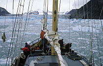 Sailboat approaching glacier, Lemaire Channel, Antarctica