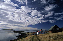 Cabins and dirt road overlooking bay, New Island, West Falkland