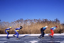 Ice skaters on frozen pond, Europe