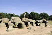 Children climbing on dolmens, ancient burial structures, Denthe region, Netherlands