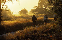 Cyclists on path at sunset
