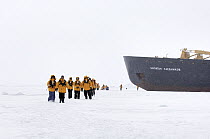Passengers of the icebreaker Kapitan Khlebnikov walking across icefield, Antarctica