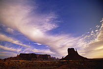Cirrus and cumulus clouds over Mittens, a group of sandstone mesas, Monument Valley Navajo Tribal Park, Arizona