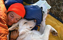Photojournalist Yva Momatiuk resting with her dog named Mis, Canada