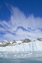 Twitcher Glacier beneath mountains of Salversen Range with bergy bits melted from calving chunks of ice, South Georgia Island, Southern Ocean, Antarctic Convergence