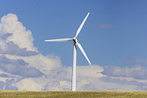 Windfarm turbine at work in high desert grasslands, summer, noon, Wyoming