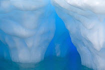 Iceberg with arches and columns sculpted by waves and melting of ice, Gerlache Passage, Antarctica