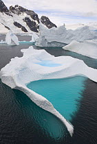 Emerald pool in iceberg, stranded in shallow bay near Booth Island, Antarctica