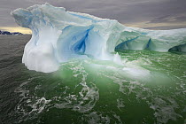 Iceberg sculpted by melting of ice and pounding waves, Cape Evensen, western Antarctica