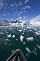 Icebergs and ice floes in front of coastline, western Antarctica