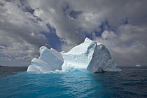Blue iceberg sculpted by waves and melting action accelerated by global warming and climate change, South Georgia Island