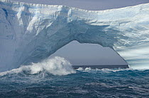 Massive blue and white iceberg with arch sculpted by waves and melting action, South Georgia Island