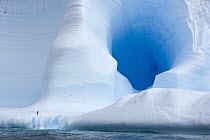 Detail of blue iceberg and caves dramatically sculpted by waves and melting action accelerated by global warming and climate change near South Georgia Island