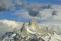 Fitzroy Massif with snow fields under cumulus and lenticular clouds, Andes, Los Glaciares National Park, Patagonia, Argentina