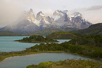 Cuernos del Paine peaks in morning light covered with cumulus clouds, Torres del Paine National Park, Patagonia, Chile