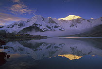 Baruntse, 7220 meters elevation, and mountaineering camp reflected in alpine lake, Makalu-Barun National Park, Nepal