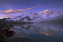 Baruntse, 7220 meters elevation, and mountaineering camp reflected in alpine lake, Makalu-Barun National Park, Nepal
