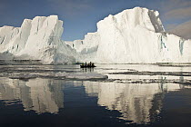 Tourists in zodiac looking at iceberg grounded off Coulman Island, Ross Sea, Antarctica