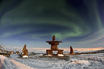 Aurora borealis over inukshuks, Churchill, Manitoba, Canada