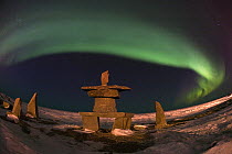 Aurora borealis over inukshuks, Churchill, Manitoba, Canada