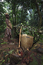 Baka woman with large basket for traveling through the rainforest, Cameroon