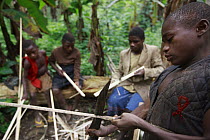 Baka children making toy crossbows, Cameroon