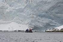Tourists in inflatable boat viewing glacier, South Georgia Island