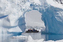 Tourists checking out iceberg from inflatable boat from the Endeavour cruise ship, Antarctica