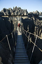Tourist crossing a suspension bridge, Bemaraha National Park, western Madagascar