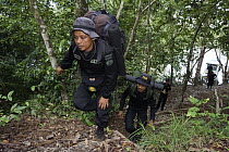 Rhino protection unit personnel entering Way Kambas National Park at the beginning of a patrol, Way Kambas National Park, Sumatra, Indonesia