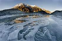 Ice bubbles in Mueller Lake with Mount Wakefield in background, Mount Cook National Park, New Zealand