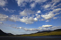 Cumulus clouds in blue sky over hills, Kongakut River, Arctic National Wildlife Refuge, Alaska