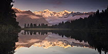 Mount Cook and Mount Tasman reflected in Lake Matheson at sunset near Fox Glacier, New Zealand