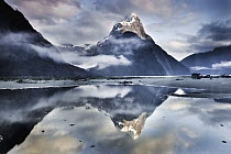 Mitre Peak reflecting in Milford Sound in winter at dawn, Fiordland National Park, New Zealand