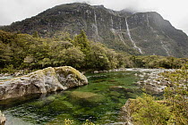 Waterfalls drain into Cleddau River, Fiordland National Park, New Zealand