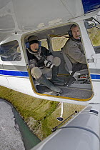 Wildlife photographer Ingo Arndt taking aerial pictures from bush plane, National Arctic Wildlife Refuge, Alaska