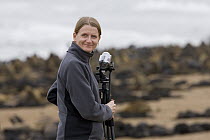 Videographer Silke Arndt with Cape Fur Seal (Arctocephalus pusillus) colony, Cape Cross, Namibia