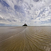 Mont Saint-Michel with waves in surrounding bay, Normandy, France