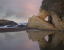 Cave reflected in pool at dusk, Spooner's Cove, Montano de Oro State Park, California