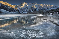 Mount Sefton reflected in frozen lake, Mueller Glacier, Mount Cook National Park, New Zealand