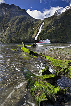 Bowen Falls with cruise vessel passing, Milford Sound, Fjordland National Park, New Zealand